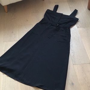 Woman’s DKNY black sleeveless dress with belted elastic waist. Size 10. Pockets!